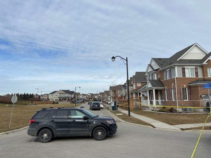 A vehicle parked beside police tape at the scene of a Halton police homicide investigation in Milton, Ont.