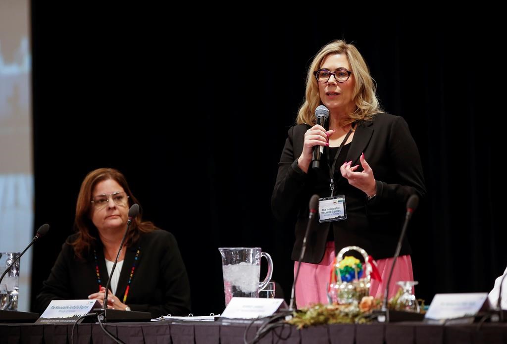 Manitoba Premier Heather Stefanson listens in as Rochelle Squires, minister of families, speaks at an event in Winnipeg on Tuesday, Jan. 31, 2023. 