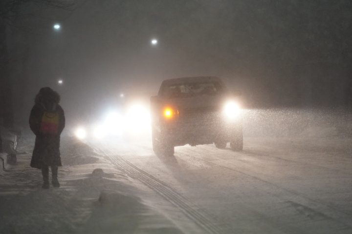Cars drive during a snow storm in Toronto, Friday, March 3, 2023.