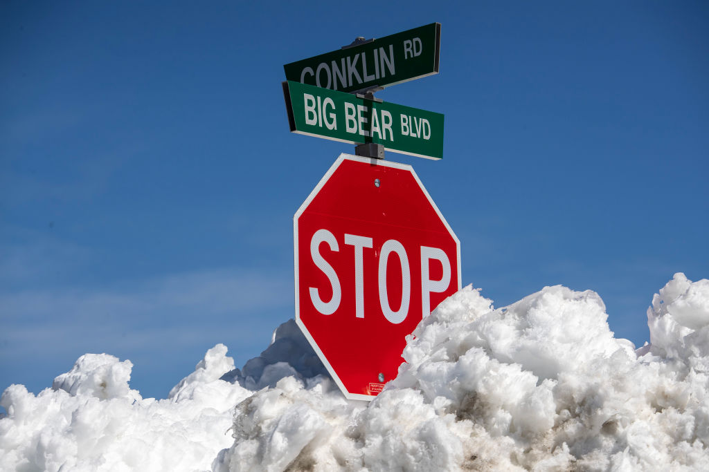 Many street signs are nearly covered as the Big Bear Valley digs out following successive storms which blanketed San Bernardino Mountain communities on Friday, March 3, 2023 in Big Bear Lake, Calif.