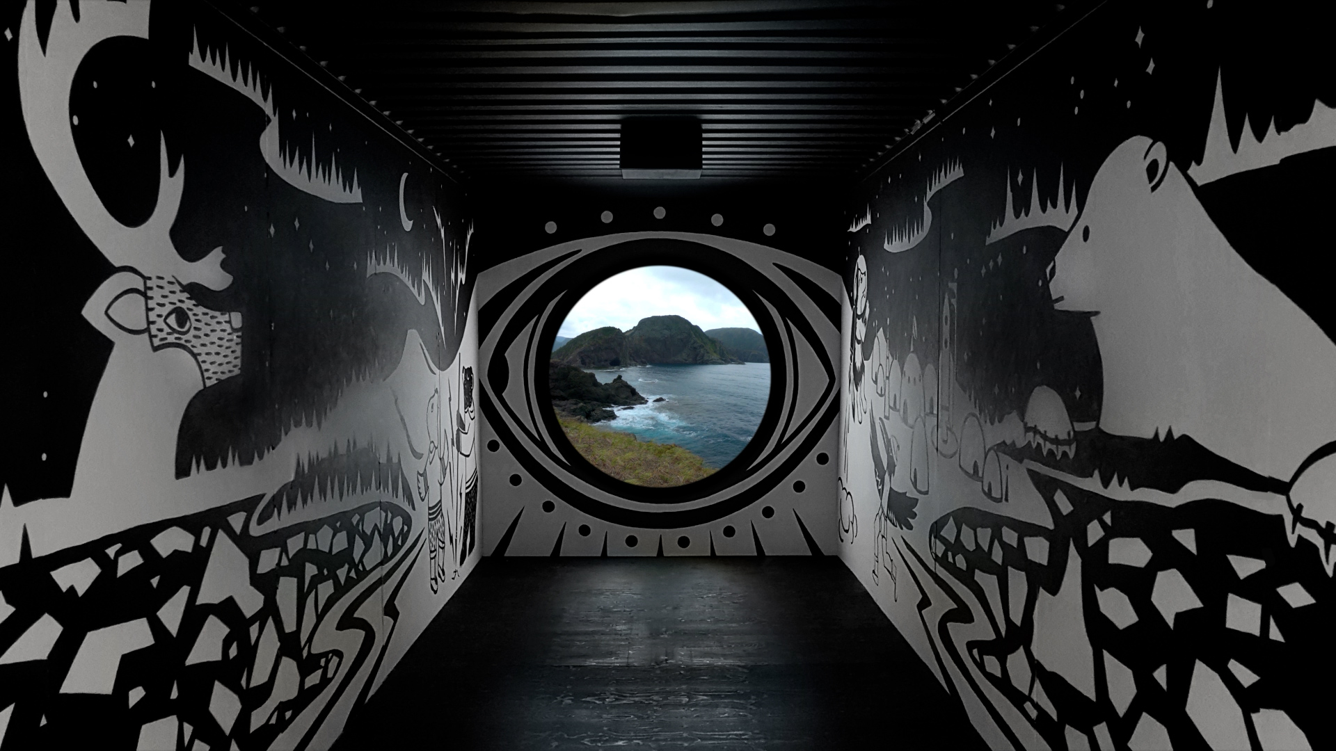 Inside a shipping container, used as a large-scale art installation. It's painted with black and white murals and has a porthole straight ahead, flashing images of the Labrador coastline.