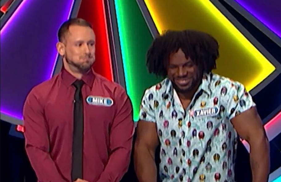 Mike Bozzuffi and Xavier Woods try to hold in their amusement.