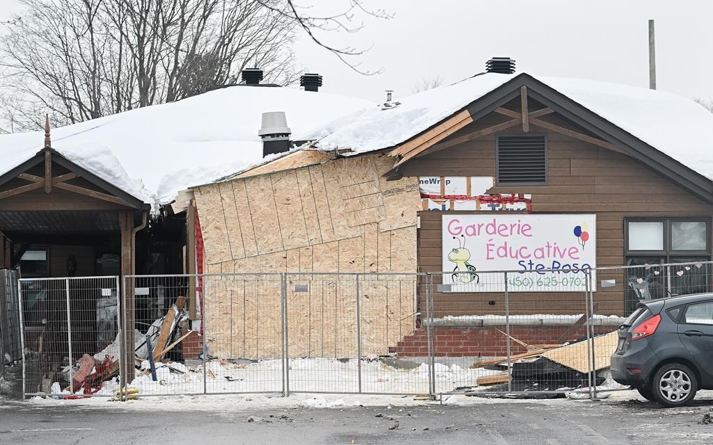 The scene outside a daycare centre in Laval, Que., Thursday, Feb. 9, 2023, where a bus crashed into the building, killing two children.