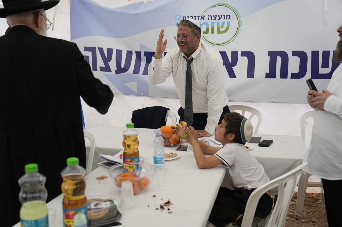 National Security Minister Itamar Ben-Gvir greets people at the outpost of Eviatar in the West Bank, Monday, April 10, 2023. Thousands led by hardline ultranationalist Jewish settlers marched to the unauthorized settlement outpost Eviatar in the northern West Bank that was cleared by the Israeli government in 2021, protected by a large contingent of Israeli soldiers and police. (AP Photo/Ariel Schalit)