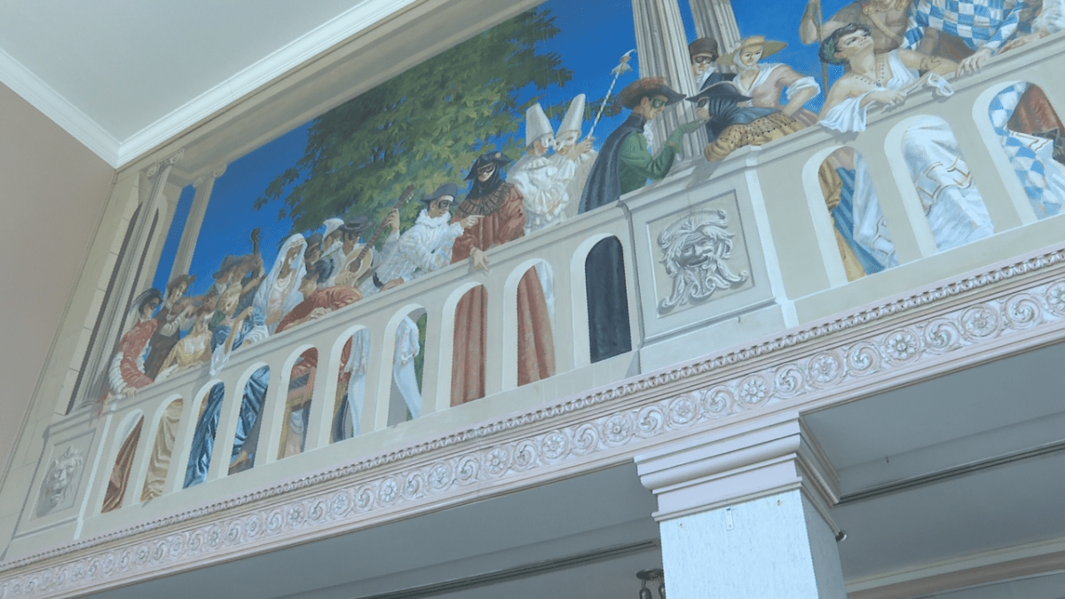 A mural is painted on the walls of regals and jesters — a tribute to live theatre — that has withstood the test of time.