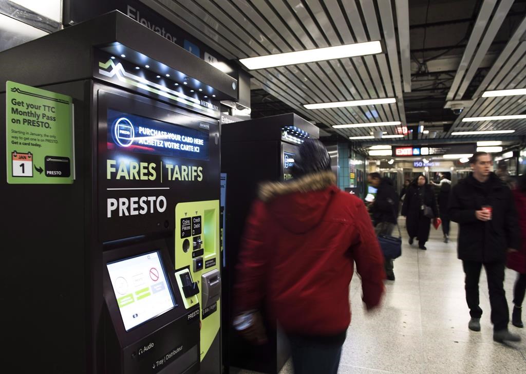 People walk past Presto machines underground in the TTC subway portals in Toronto on December 4, 2018. 