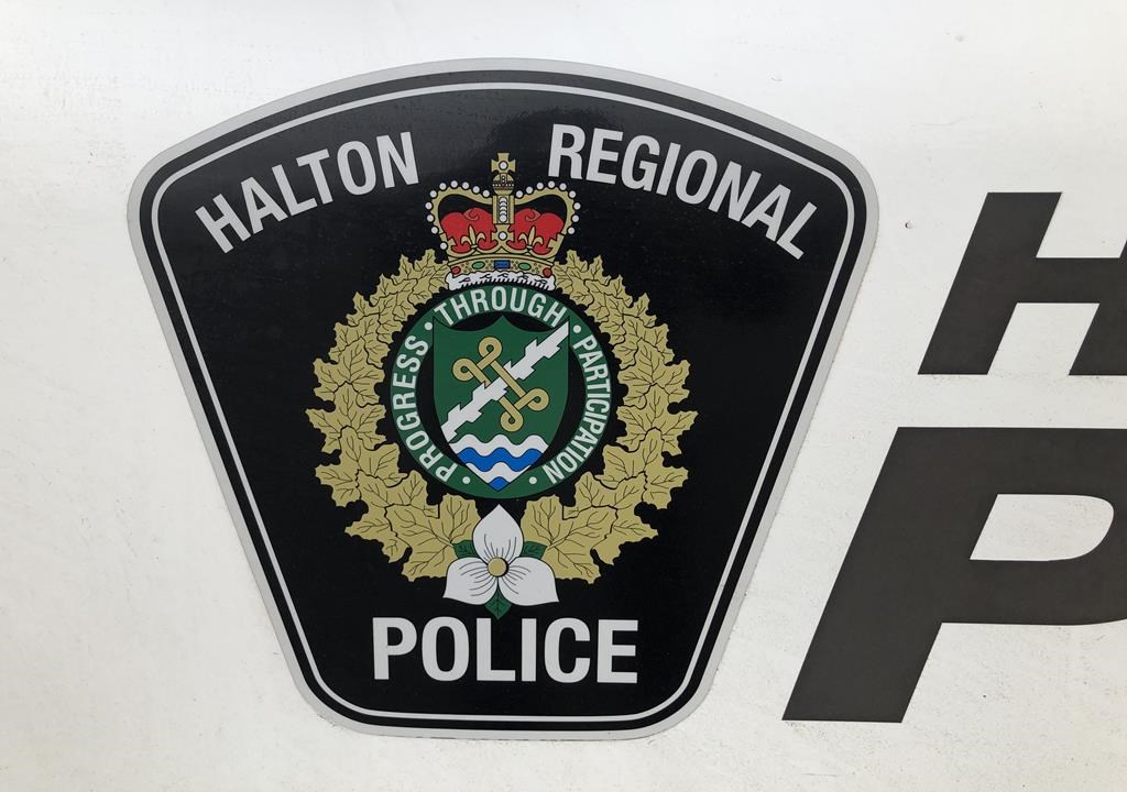 A Halton regional police logo is shown on a vehicle in Oakville, Ont. Police are seeking a carjacking suspect after an individual took a vehicle following a crash in Burlington, Ont., March 13, 2024.