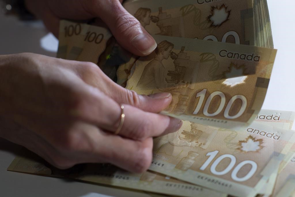 Canadian $100 bills are counted in Toronto, Feb. 2, 2016.