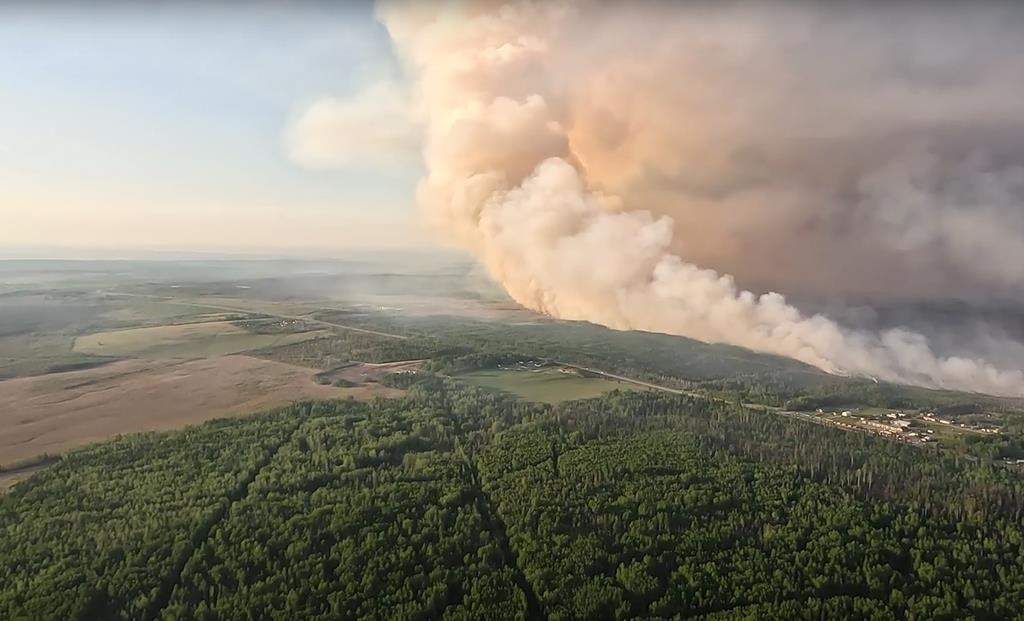 All evacuation orders related to wildfires in northeastern British Columbia have now been lifted or downgraded to evacuation alerts as heavy rain eases the fire danger. The Peace River Regional District has cancelled orders issued last week affecting properties threatened by the Stoddart Creek fire northeast of Fort St. John. Smoke is shown as the Stoddart Creek wildfire burns in British Columbia in this May 14, 2023, handout image taken from video. THE CANADIAN PRESS/HO-BC Wildfire Service **MANDATORY CREDIT**.