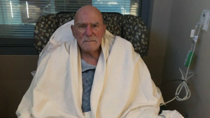 'Superstar' Billy Graham in a blanket, sitting in a chair.