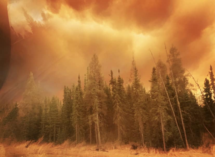 Smoke fills the sky near a wildfire in northern Alberta that forced residents of Fox Lake to flee.