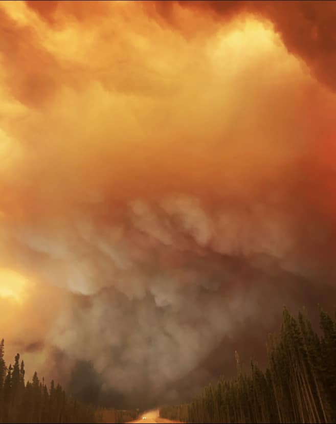 Smoke fills the sky near a wildfire in northern Alberta that forced residents of Fox Lake to flee.