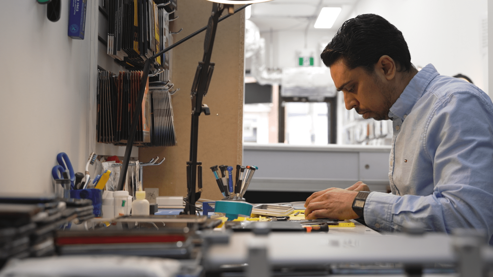 Repair technician Rayhan Mohammed Siraj fixes smartphones at his shop, Phone Solutions in Toronto, Ont.