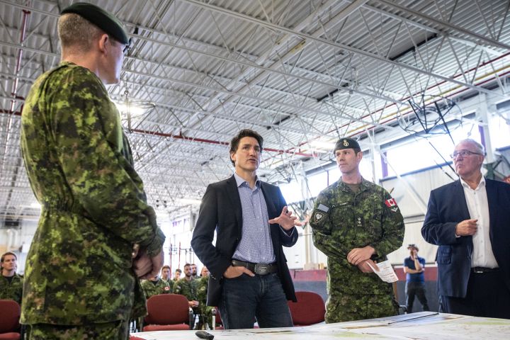 From left, General Steve Graham, Prime Minister Justin Trudeau and Colonel Ben Schmidt and Mp Bill Blair discuss the Alberta wildfires while meeting with members of the Canadian Armed Forces who are assisting in the Alberta wildfires, in Edmonton on Monday, May 15, 2023. THE CANADIAN PRESS/Jason Franson