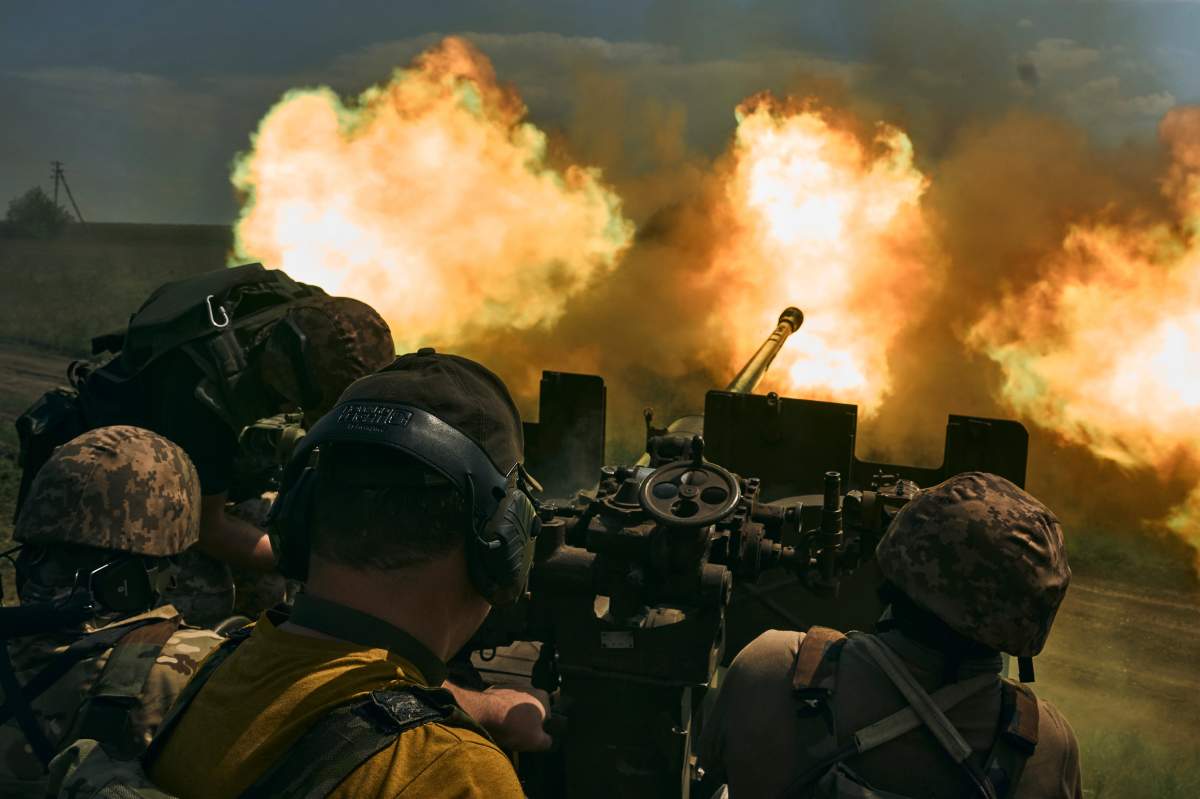 Ukrainian soldiers fire a cannon near Bakhmut, an eastern city where fierce battles against Russian forces have been taking place, in the Donetsk region, Ukraine, Monday, May 15, 2023. (AP Photo/Libkos)