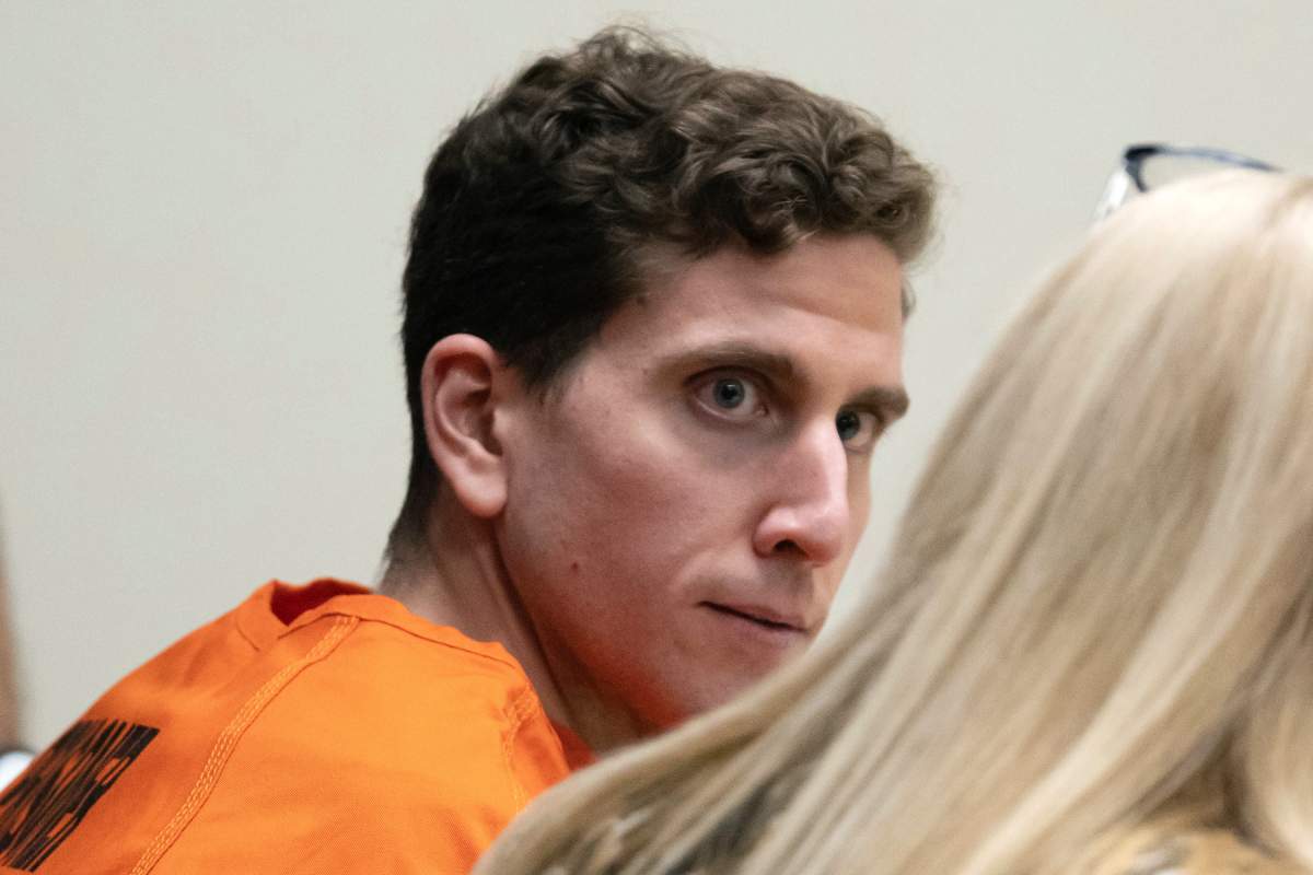 Bryan Kohberger sits wearing an orange jumpsuit.
