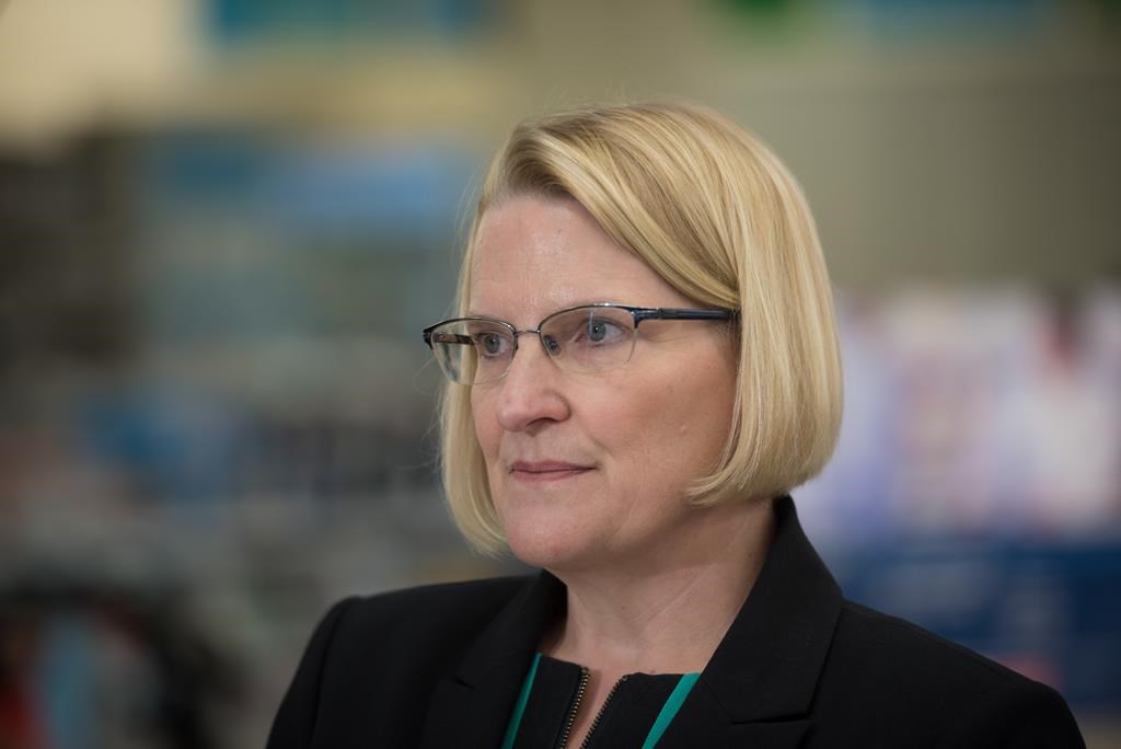 Ontario Health Minister Sylvia Jones listens to questions from reporters following a press conference at a Shoppers Drug Mart pharmacy in Etobicoke, Ont., on Wednesday, January 11, 2023.
