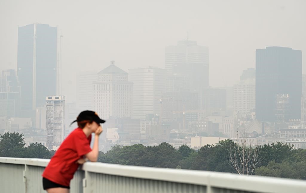 The skyline of Montreal is obscured by a haze of smog, Sunday, June 25, 2023. Smoke from the wildfires burning across northern Quebec is grounding the province’s water bombers and causing widespread smog warnings futher south.