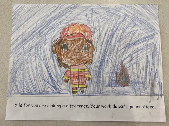 "Y is for you are making a difference. Your work doesn't go unnoticed." read another page of the booklet, accompanied by a student's drawing of a firefighter.