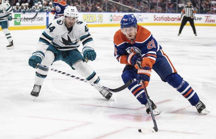 San Jose Sharks' Marc-Edouard Vlasic (44) chases Edmonton Oilers' Mattias Janmark (26) during second period NHL action in Edmonton on Monday March 20, 2023.