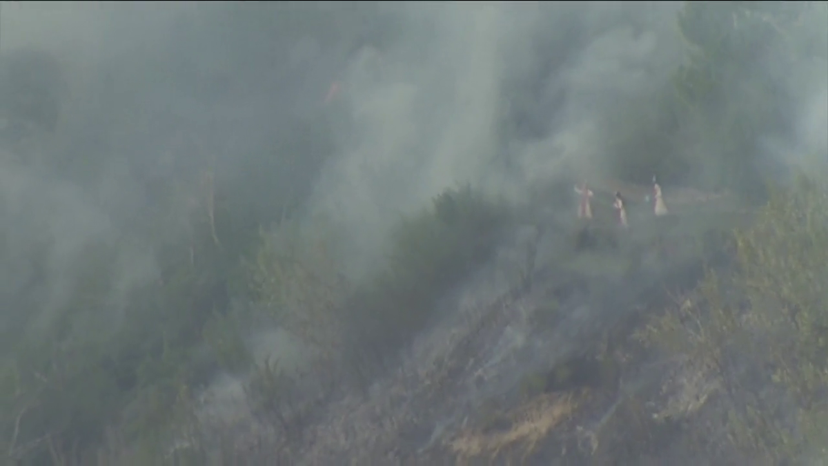 Nuns trying to put out a grass fire at the Sisters of the Precious Blood monastery located near the southwest neighbourhoods of Roxboro and Mission.
