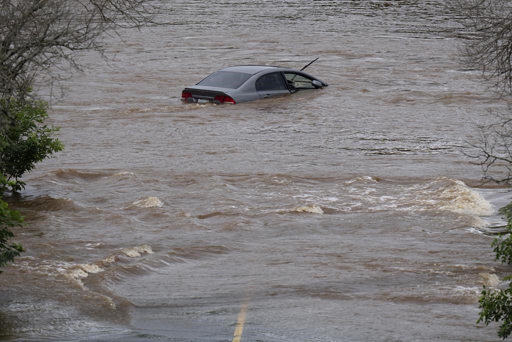 An abandoned car in a mall parking lot is seen in floodwater following a major rain event in Halifax on Saturday, July 22, 2023.