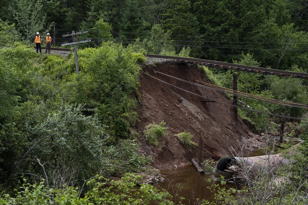 Workers with CN Rail assess the damage to a washed-out rail line outside of Truro, N.S. on Sunday, July 23, 2023.