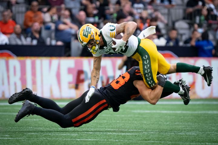 B.C. Lions linebacker Ben Hladik (46) tackles Edmonton Elks wide receiver Vincent Forbes-Mombleau (82) during the first half of a CFL football game, in Vancouver, on Saturday, June 17, 2023. On Saturday night, the Elks’ home game versus the Lions will be the first pro football contest to be broadcast in Punjabi. This comes after the franchise registered another first in 2022 by having a regular-season matchup carried in Cree.