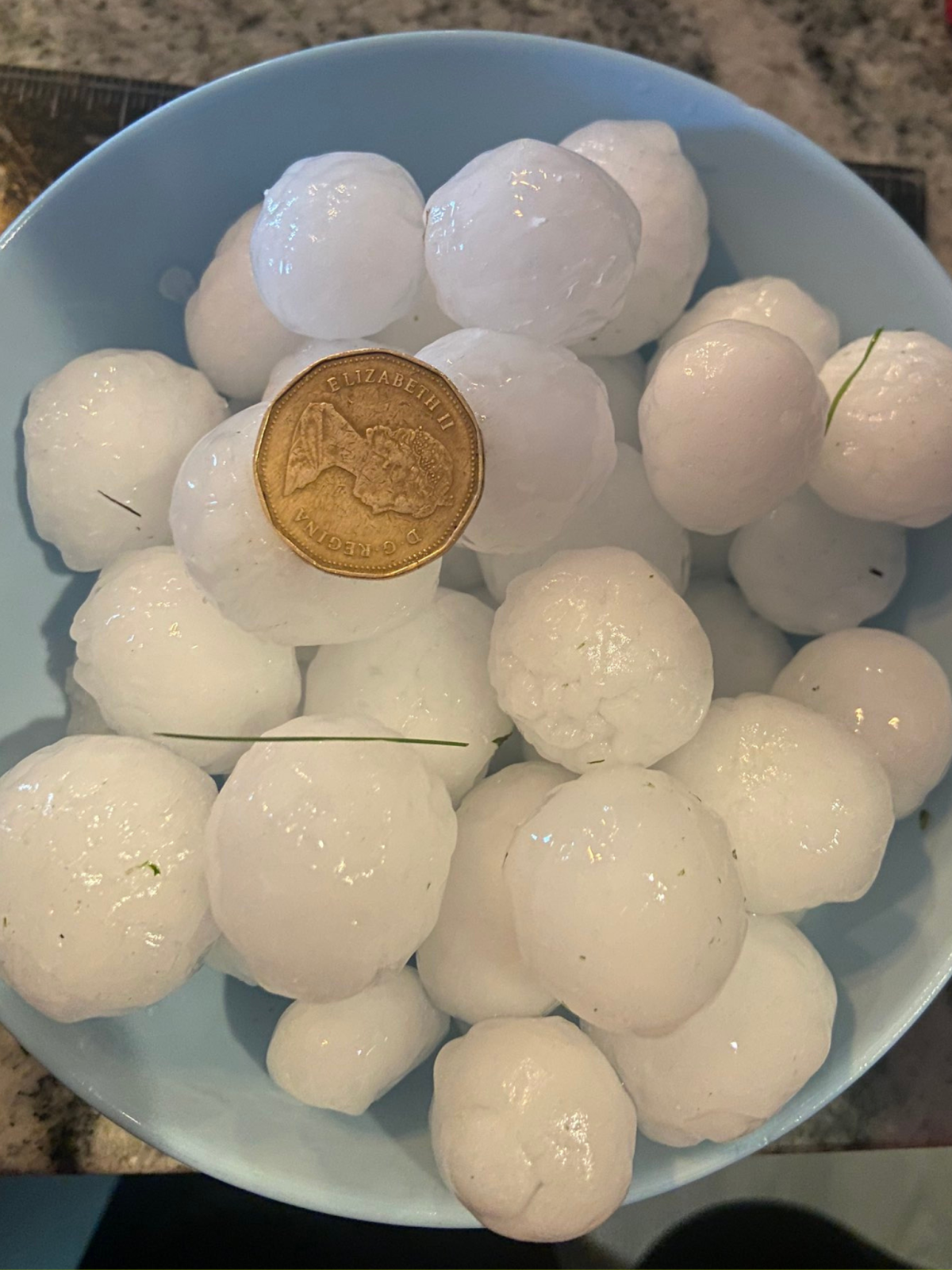 A photo of the ping pong ball sized hail seen in Calgary on July 17, 2023.
