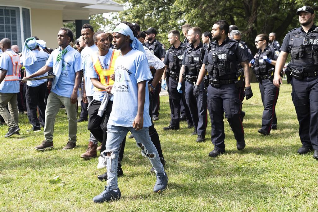 Toronto Police work the scene of a protest that turned violent in Earlscourt Park in Toronto, on Saturday, August 5 2023. Toronto police say one person was stabbed and eight others were injured during a protest in the city’s west end. THE CANADIAN PRESS/Arlyn McAdorey