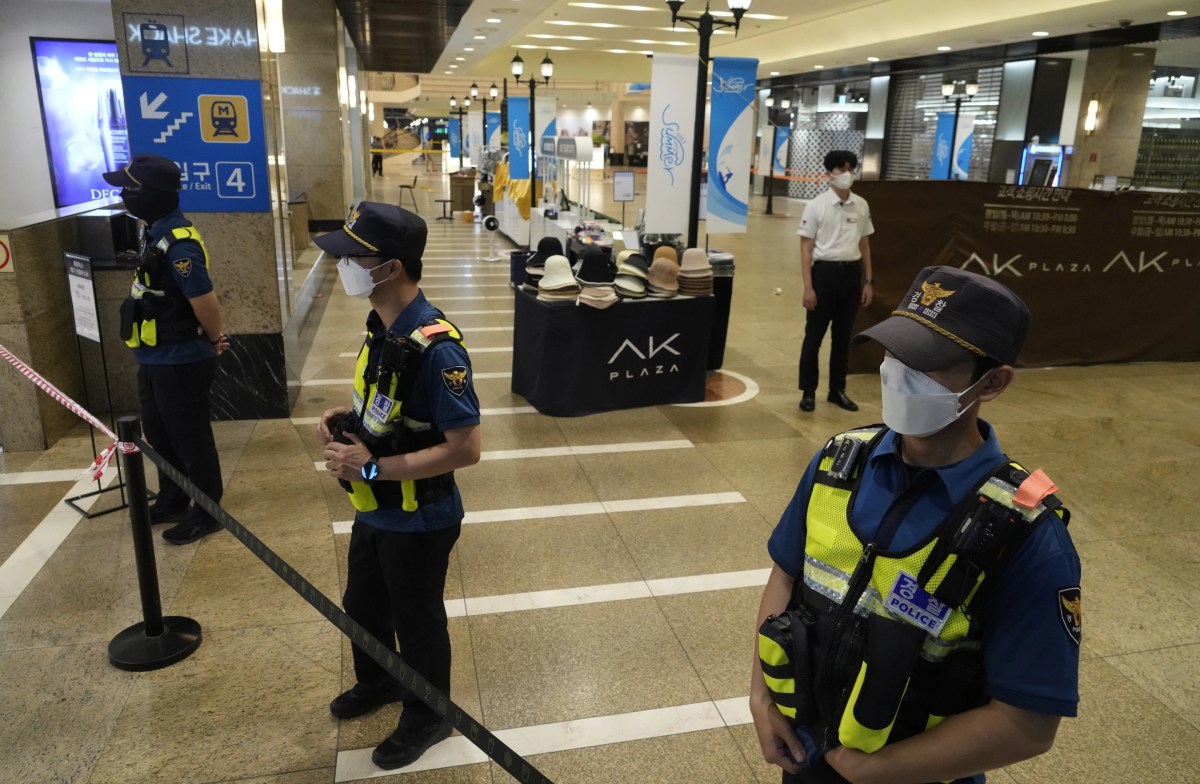 Uniformed police stand in a line.