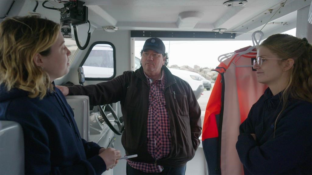 Hubert Nicholas, former director of Fisheries at Membertou First Nation, speaks with engineers Erica Pineo, left, and Marissa Campbell in a 2022 handout photo. A new study by an environmental group has concluded that a switch from diesel to electric lobster boats is viable for about 2,300 boats operating off Nova Scotia. THE CANADIAN PRESS/HO-Ocean North.