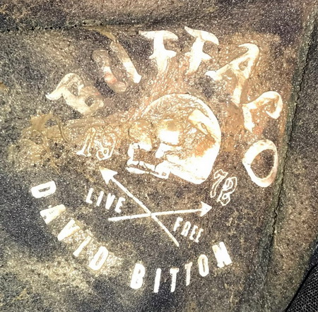A black hoodie with a skull logo and the words ‘Buffalo 1972 David Bitton’ was found on the body.