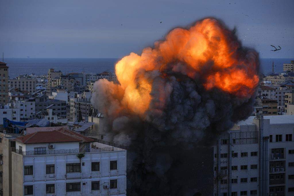Fire and smoke rise following an Israeli airstrike, in Gaza City, Sunday, Oct. 8, 2023. A group from a B.C. church was on a tour in Israel to explore the historical sites when the Israel-Hamas war broke out on Saturday, leaving the group struggling to find a way home.THE CANADIAN PRESS/AP/Hatem Moussa.