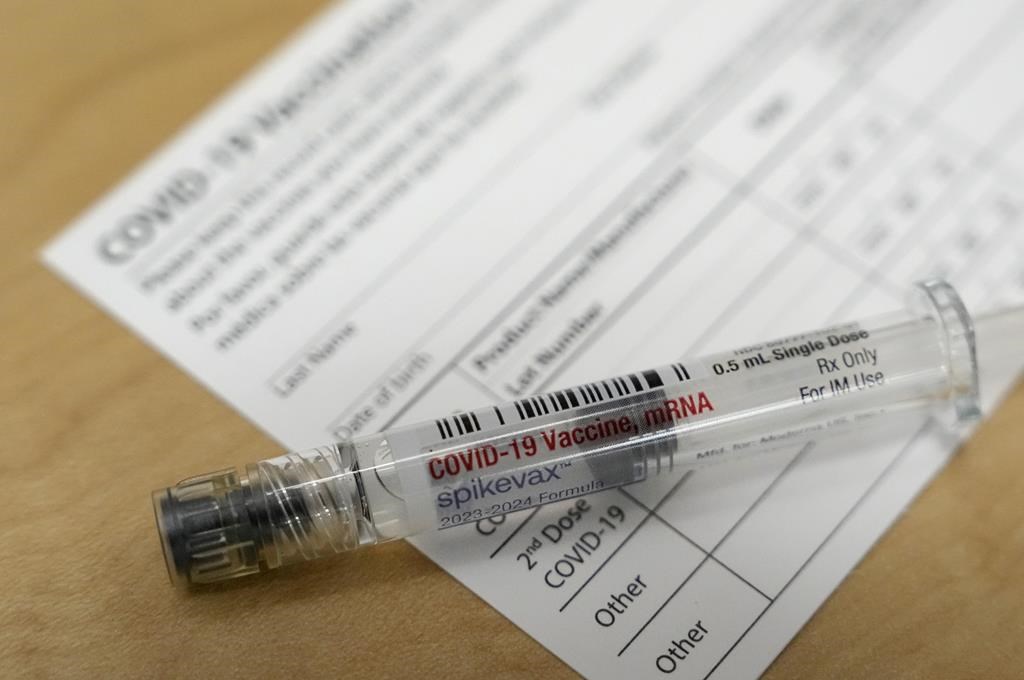 FILE - A Moderna Spikevax COVID-19 vaccine is seen at a drugstore in Cypress, Texas, Sept. 20, 2023.