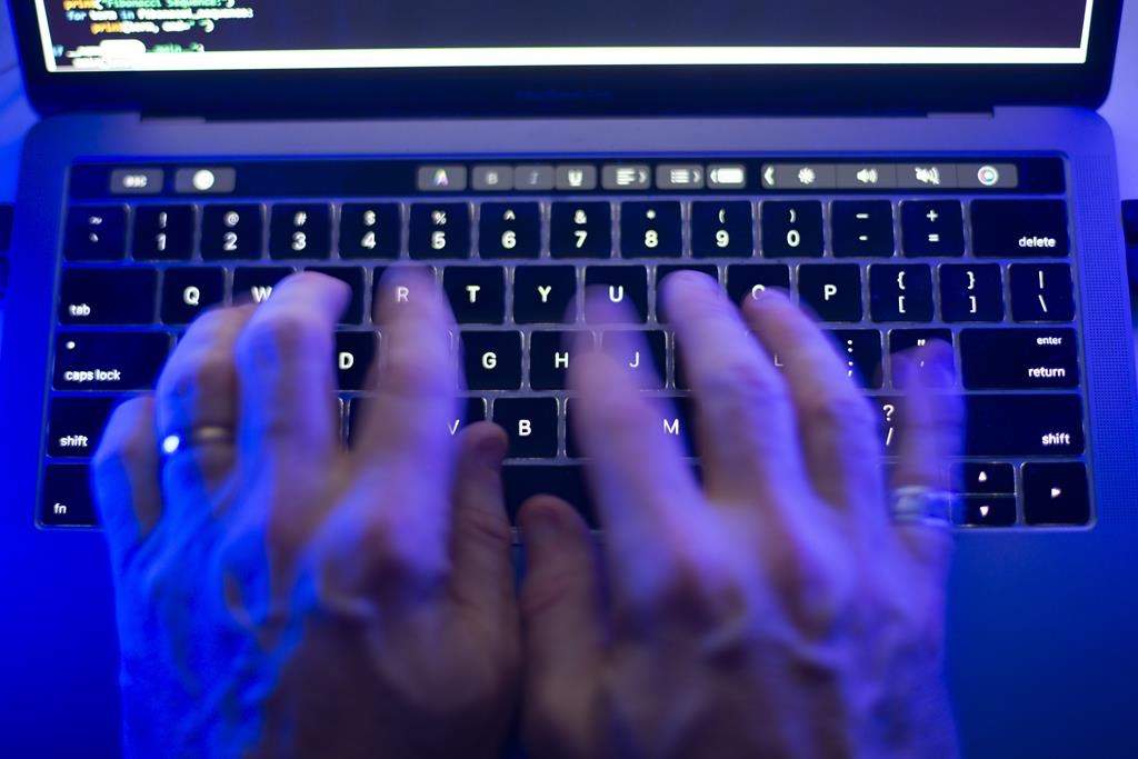 The Toronto Public Library says it is dealing with a cybersecurity incident that's affecting its website and some in-branch services. A man uses a computer keyboard in Toronto, Monday, Oct. 9, 2023 in this photo illustration. 