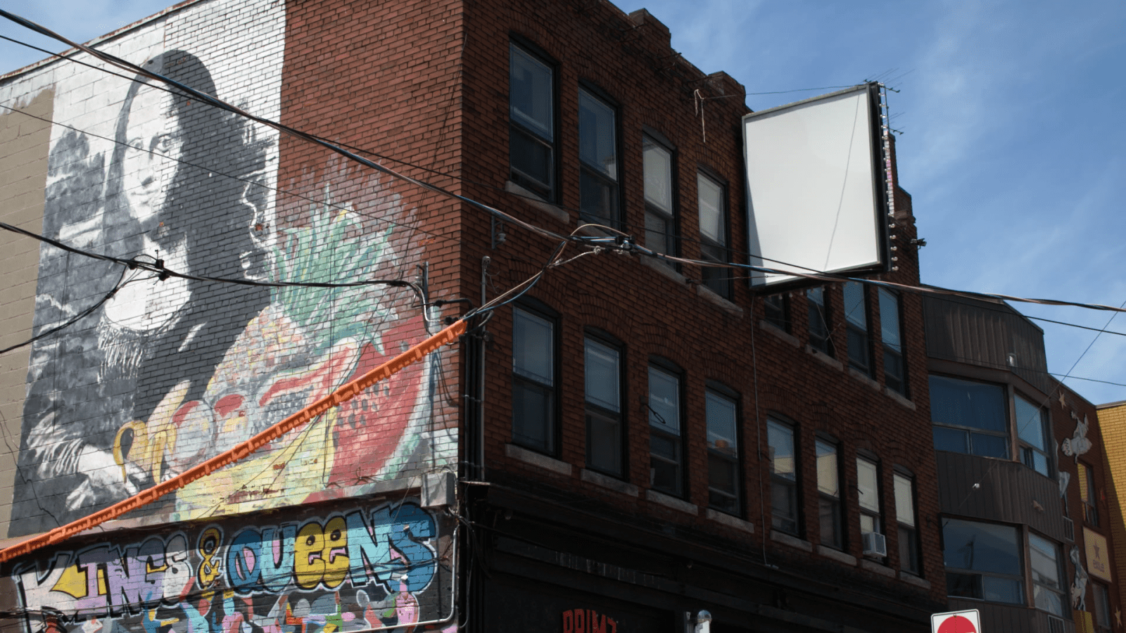 The “Mona Lisa Building” at the corner of Kensington Ave and St. Andrew Street was the Kensington Market CLT’s first purchase. It contains 12 residential units and five local businesses.