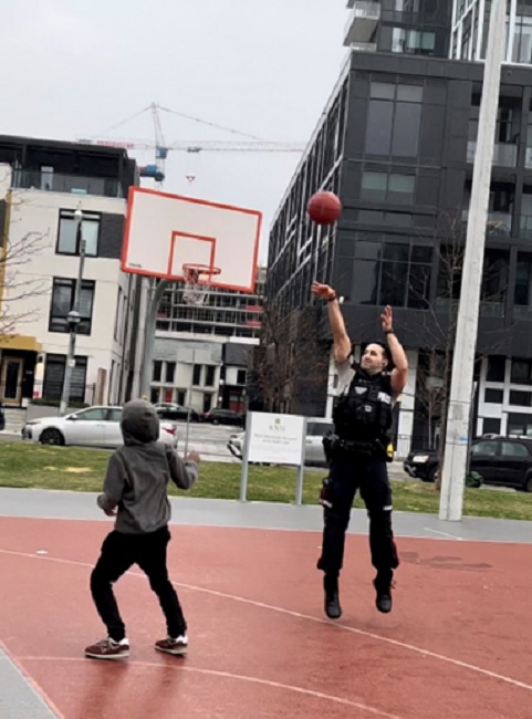 Mustafa Popalzai plays basketball with youth in Regent Park