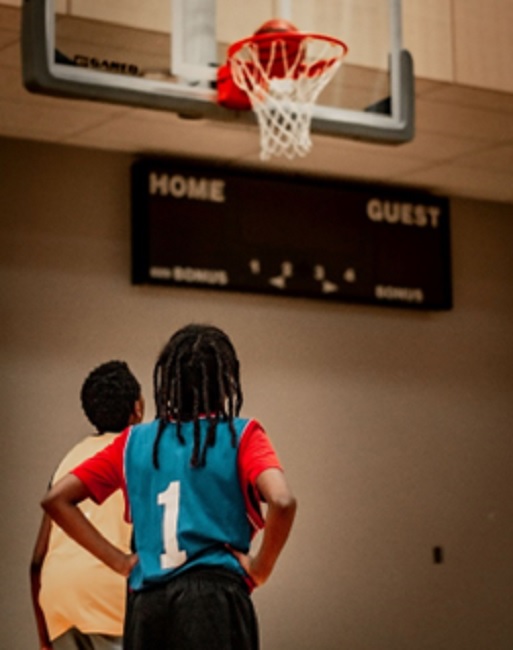 Children play basketball in a local community centre. Popalzai worked within the community to encourage the kids of Regent to return to the courts.