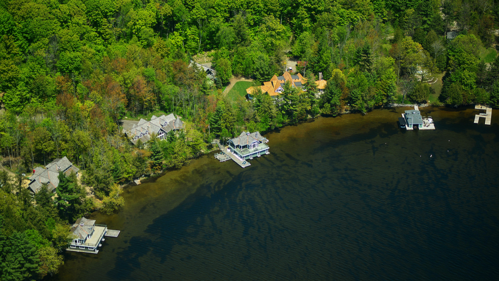 Cottages line the shores of the Muskoka lakes in this aerial photograph taken above Muskoka, Ontario, Canada, on May 23, 2015.