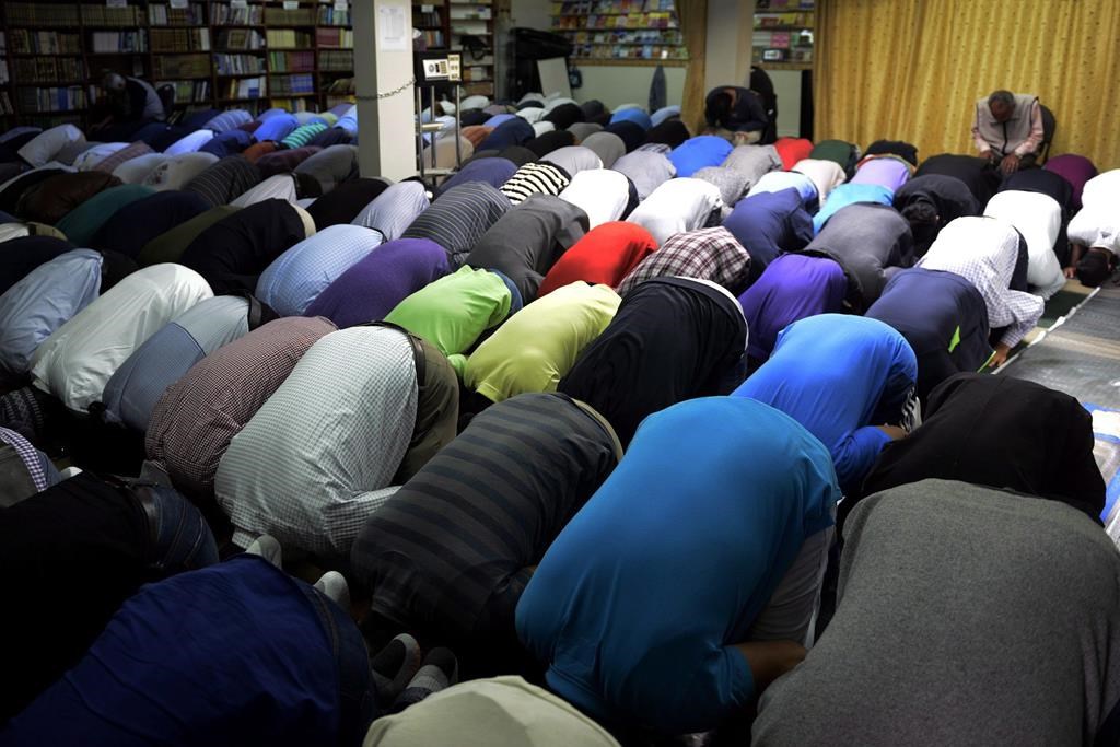 After a man allegedly called a group of Muslims "terrorists" before nearly striking them with a boulder outside a Toronto area mosque where kids and adults were gathered to pray, a rabbi sent a message to the worshippers to express sympathy. People attend prayers at the Toronto Islamic Centre on Friday, Sept. 25, 2015. THE CANADIAN PRESS/Marta Iwanek.