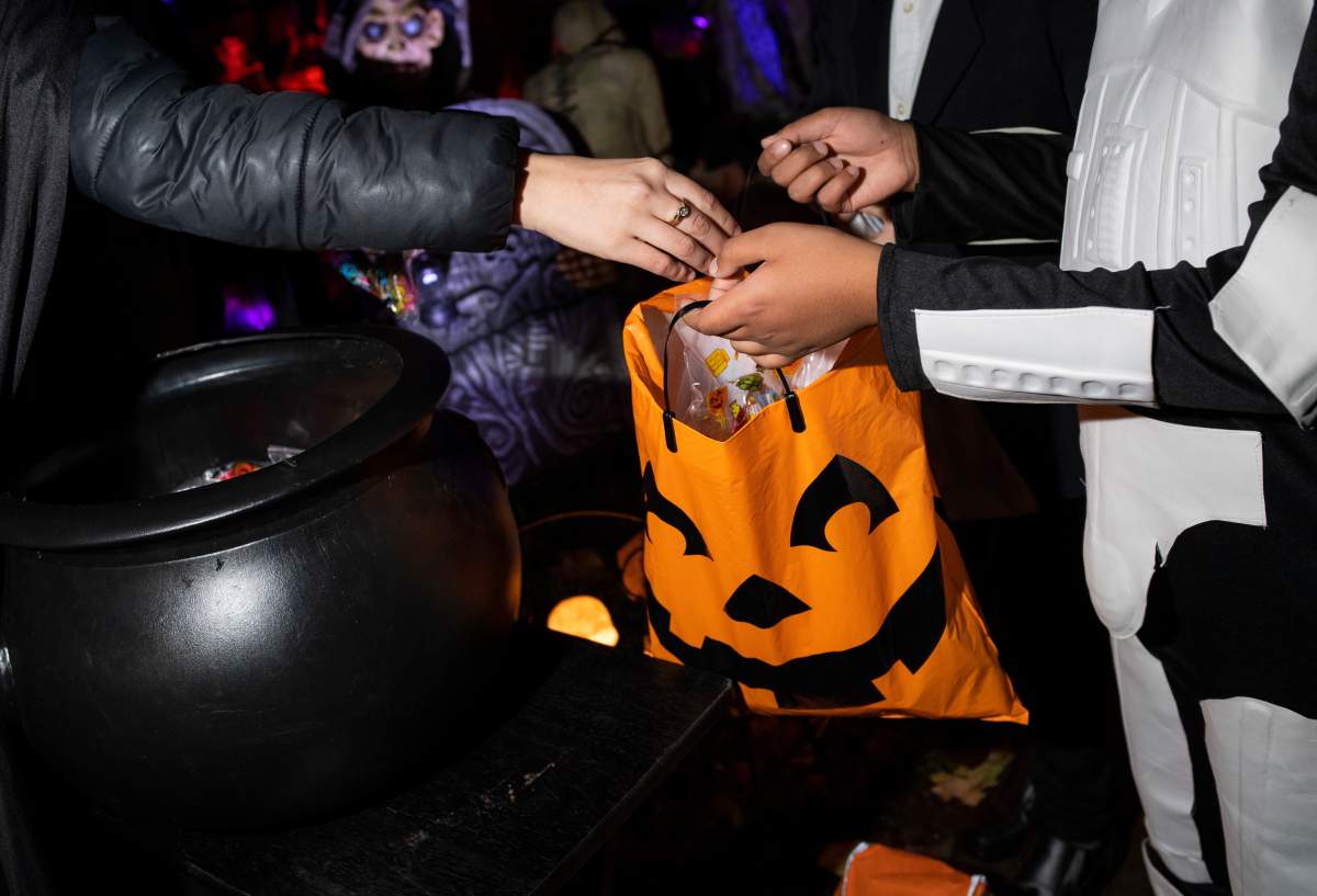 A trick-or-treater gets a bag of candy on Halloween night in this file photo.
