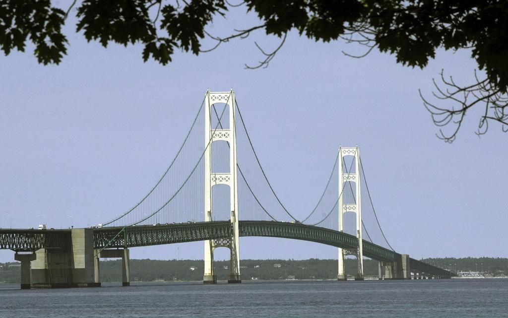 FILE - This July 19, 2002, file photo, shows the Mackinac Bridge that spans the Straits of Mackinac from Mackinaw City, Mich. Michigan regulators have approved a $500 million plan to encase a portion of an oil pipeline that runs beneath a channel connecting two Great Lakes. The state Public Service Commission on Friday, Dec. 1, 2023, approved the proposal for the tunnel through the Straits of Mackinac.