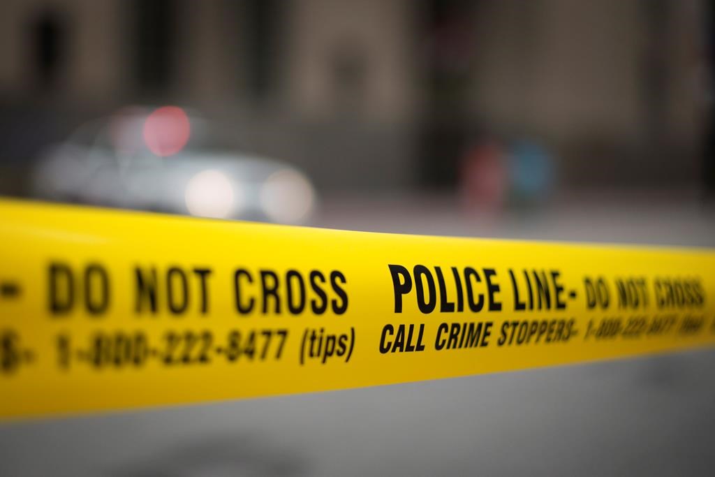 Police investigate after a man was pronounced dead and another is injured after a double shooting Friday night. Police tape is shown in Toronto on Tuesday, May 2, 2017. 