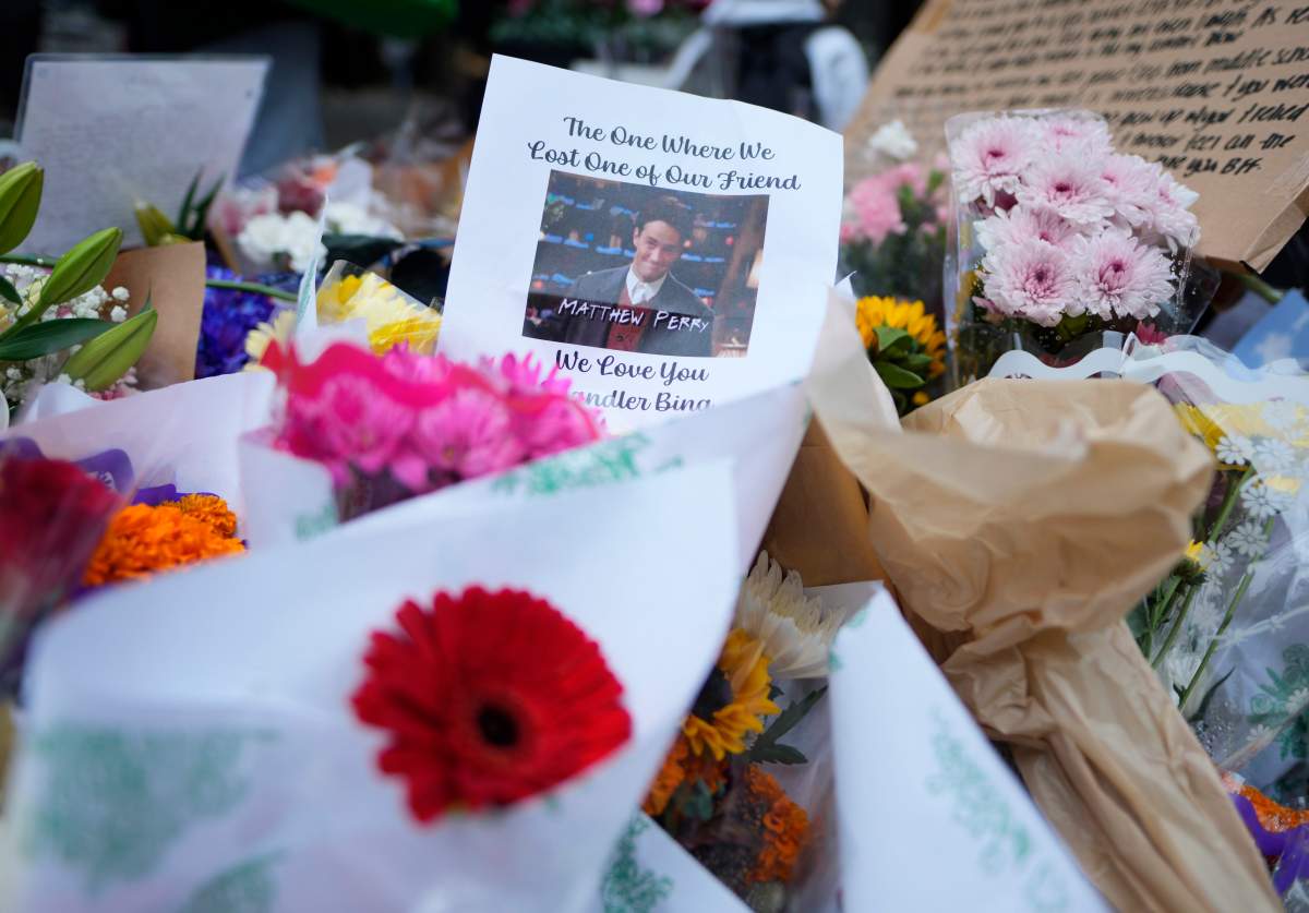 A makeshift memorial for Matthew Perry is seen outside the building shown in exterior shots of the television show “Friends” on Monday, Oct. 30, 2023, in New York. Perry, who played Chandler Bing on NBC’s “Friends” for 10 seasons, was found dead at his Los Angeles home on Saturday. He was 54. (Photo by Charles Sykes/Invision/AP)