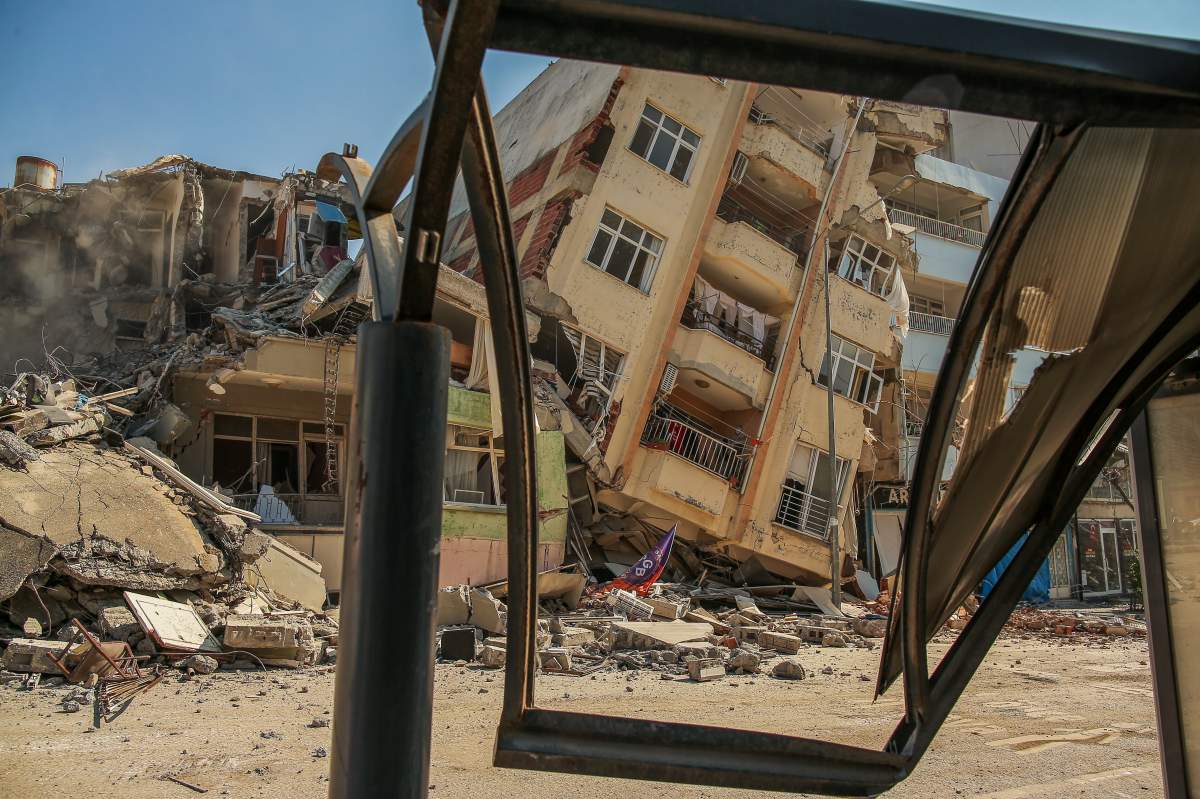 A destroyed building leans on a neighbouring house following the earthquake in Samandag, southern Turkey, Wednesday, Feb. 22, 2023. Survivors of the earthquake that jolted Turkey and Syria 15 days ago, killing tens of thousands of people and leaving hundreds of thousands of others homeless, dealt with more trauma and loss Tuesday after another deadly quake and aftershocks rocked the region. (AP Photo/Emrah Gurel)