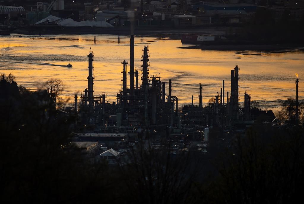 Parkland Corp.'s largest shareholder will no longer have a seat on the fuel retailer's board after the recent resignation of two board members. A boat travels past the Parkland Burnaby Refinery on Burrard Inlet at sunset in Burnaby, B.C., on Saturday, April 17, 2021.
