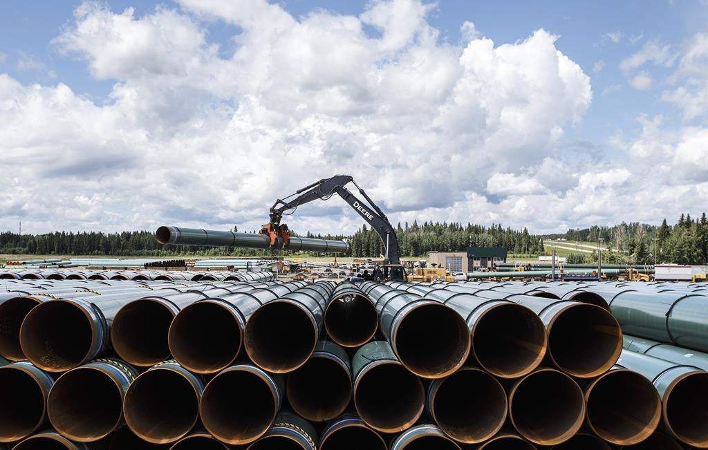 The Canada Energy Regulator will hear arguments Friday from the company building the Trans Mountain pipeline expansion on its request for a pipeline variance. Pipe for the Trans Mountain pipeline is unloaded in Edson, Alta. on Tuesday June 18, 2019.