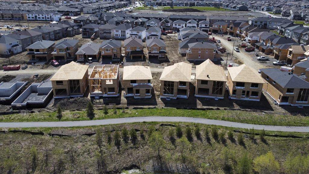 Canada Mortgage and Housing Corp. says the annual pace of housing starts in December rose 18 per cent compared with November, helped higher by an increase in multi-unit urban starts in Vancouver and Montreal. New homes are built in a housing construction development in the west end of Ottawa on Thursday, May 6, 2021. THE CANADIAN PRESS/Sean Kilpatrick.