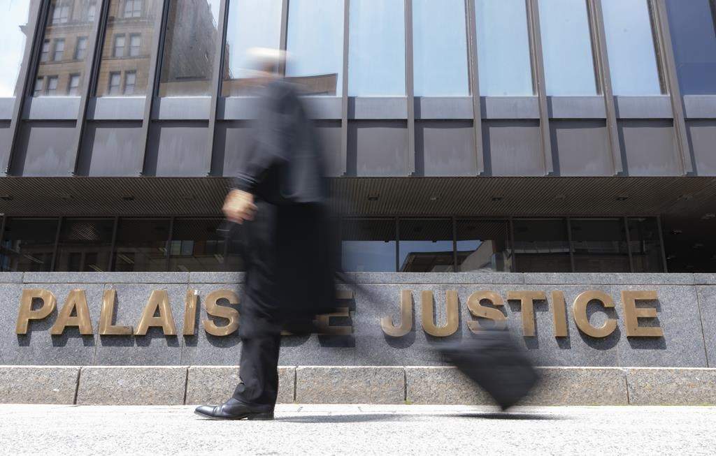 A 42-year-old Montreal man returned to court Monday after being charged with second-degree murder in the death of a woman in the city's east end. A lawyer walks past the courthouse in Montreal, Wednesday, July 12, 2023. 